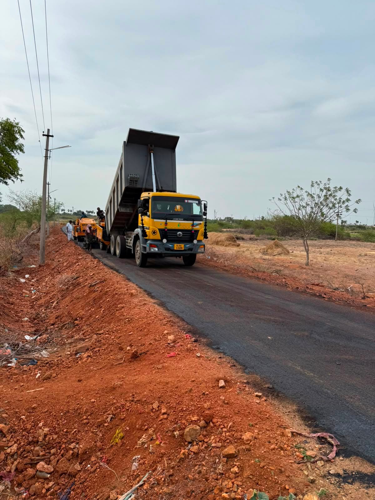 AP Infra Projects road roller and tipper truck during bituminous road laying